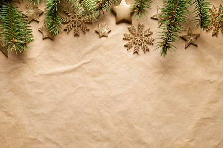 Christmas background - spruce tree, stars and snowflakes on paper sheetの写真素材