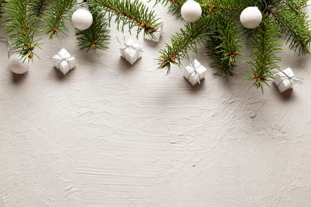 Christmas background - gifts, baubles and spruce tree on white wallの写真素材