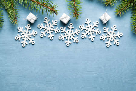 Spruce tree, Christmas gifts and snowflakes on blue backgroundの写真素材