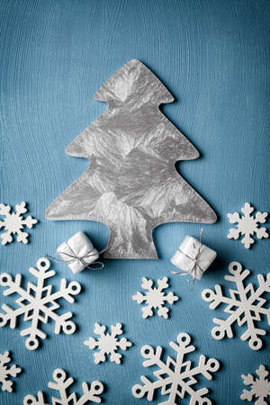 Christmas tree, snowflakes and gifts on blue backgroundの写真素材