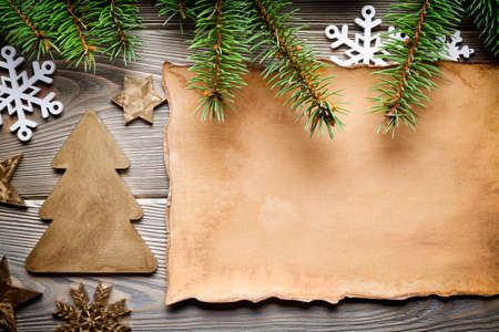 Handmade paper sheet, Christmas tree, stars, snowflakes and spruce tree on wooden boardの写真素材