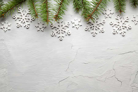 Spruce tree and snowflakes on white backgroundの写真素材