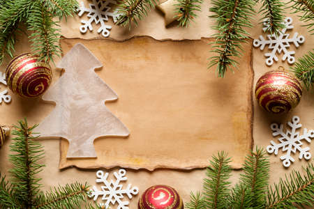 Spruce branches, Christmas baubles and snowflakes on paper backgroundの写真素材