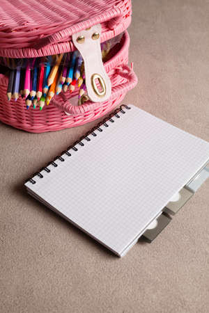Colorful pencils and notebook on tableの写真素材