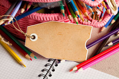 Paper label, notebook and colorful pencilsの写真素材