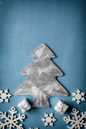 Christmas tree, snowflakes and gifts on blue backgroundの写真素材