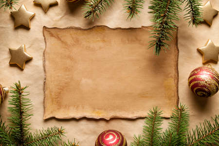 Christmas background - ornaments, spruce branches and handmade paper sheetの写真素材