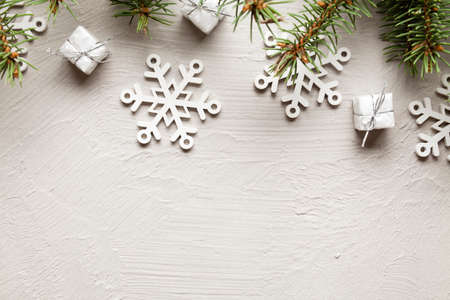 Christmas decorations - gifts, snowflakes and spruce tree on white wallの写真素材