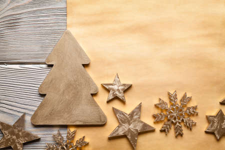 Christmas background - tree, stars and snowflakes on paper and wooden backgroundの写真素材