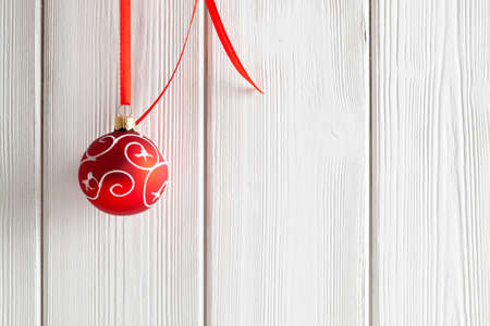 Christmas background - red bauble on white planksの写真素材