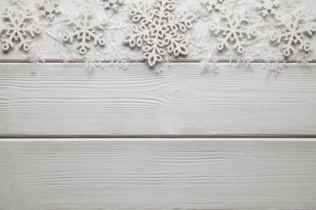 Christmas decorations - white snowflakes on wooden backgroundの写真素材