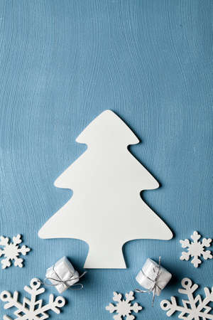 Christmas tree, snowflakes and gifts on blue backgroundの写真素材