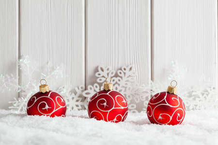 Christmas background - baubles and snowflakes on snow and white wooden planksの写真素材