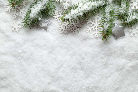 Christmas background - snowflakes and spruce tree on white snowの写真素材
