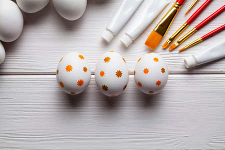 White and painted Easter eggs, brushes and paints as a symbol of painting Easter eggsの写真素材