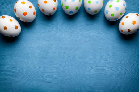 White Easter eggs on blue backgroundの写真素材