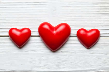 Valentines Day - Three red hearts on white planks の写真素材
