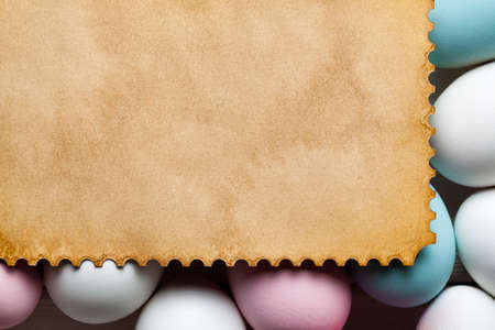 Blank handmade paper sheet and colorful eggsの写真素材