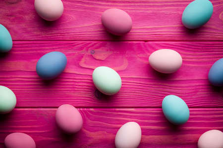 Painted Easter eggs on pink wooden planks backgroundの写真素材