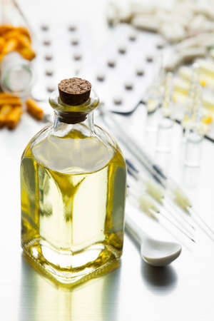 Medical syrup, various pills and injections on a metal shiny tableの写真素材