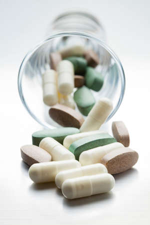 Dose of medicines - Various medical tablets on metal tableの写真素材
