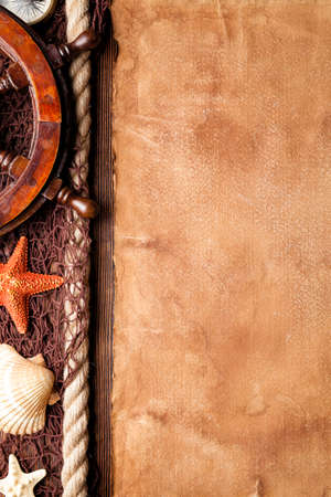 Blank paper sheet, starfish, shell, fishing net, hawser and ship's steering wheelの写真素材