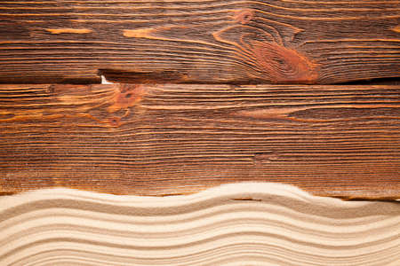 Beach sand on wooden wall background
