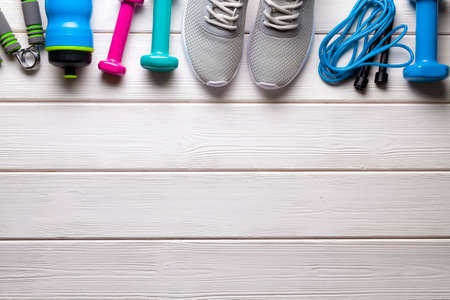 Sport symbols - fitness equipment on wooden wall backgroundの写真素材
