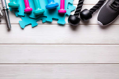 Sport background - fitness equipment on wooden boardの写真素材