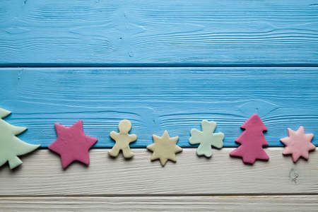 Colorful Christmas cakes on wooden backgroundの写真素材
