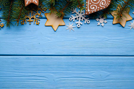 Christmas background - spruce tree, stars, snowflakes and christmas cookies on wooden backgroundの写真素材