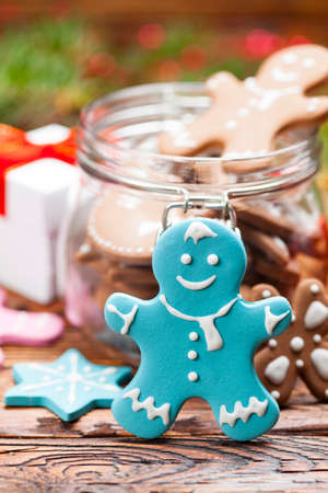 Colorful Christmas cookies in a jar and wooden tableの写真素材