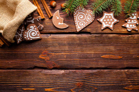 Gingerbread Christmas cookies and spruce tree on wooden backgroundの写真素材