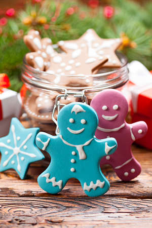 Colorful Christmas cookies in a jar and wooden tableの写真素材