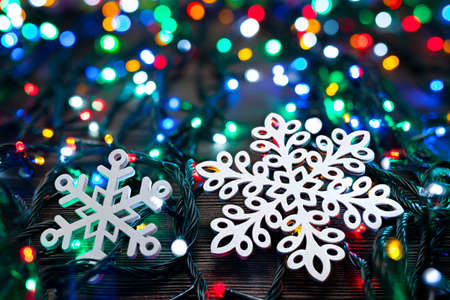 White wooden snowflakes and lights on wooden tableの写真素材