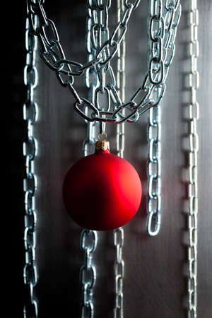 Christmas bauble and silver metal chains on steel backgroundの写真素材