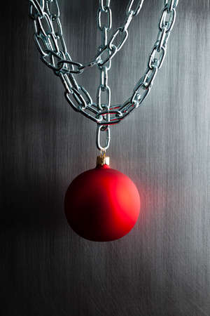 Christmas bauble and silver metal chains on steel backgroundの写真素材
