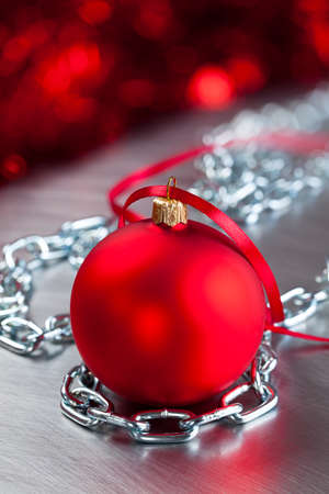 Christmas bauble and silver metal chains on steel backgroundの写真素材