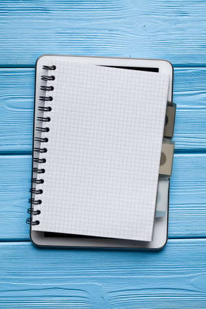 Notebook with copy space on digital tablet and blue wooden backgroundの写真素材