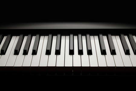 Piano keyboard on black backgroundの写真素材