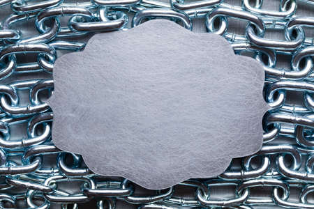 Scratched metal plate on metal chains background