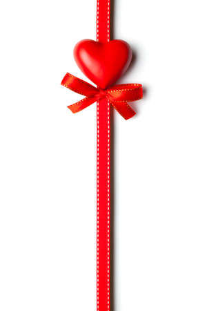 Red heart, bow and ribbon isolated on white backgroundの写真素材