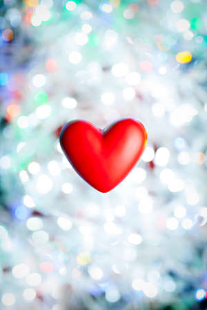 Red heart on a background of blurred lightsの写真素材
