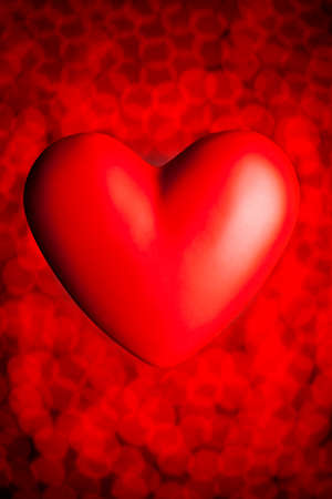 Red heart on red blurry bokeh backgroundの写真素材