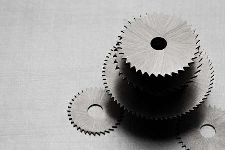 Metal disk saws on a metal tableの写真素材