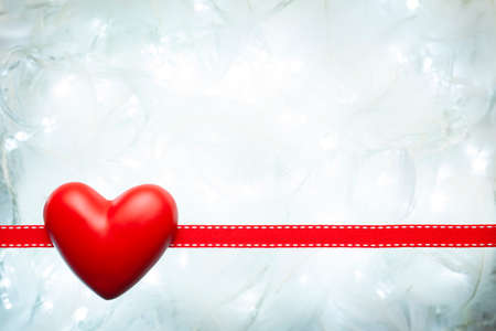 Red heart and ribbon on white abstract backgroundの写真素材