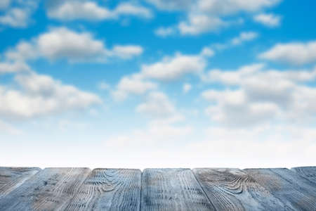 Empty wooden table on nature blue sky backgroundの写真素材