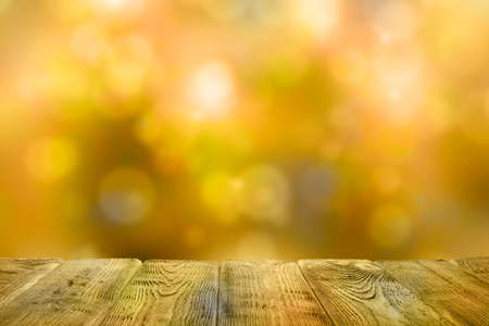 Empty wooden table on golden bokeh abstract backgroundの写真素材
