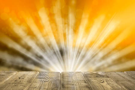 Empty wooden table on golden abstract background