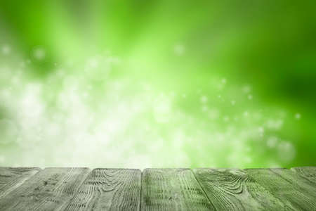 Wooden table of free space and green abstract backgroundの写真素材